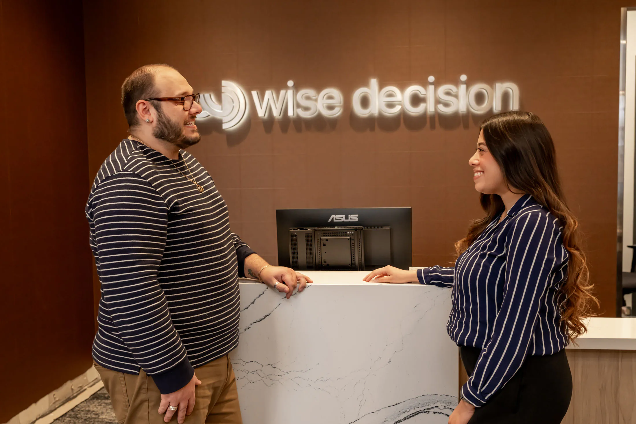 A parent and teen checking in at Wise Decision